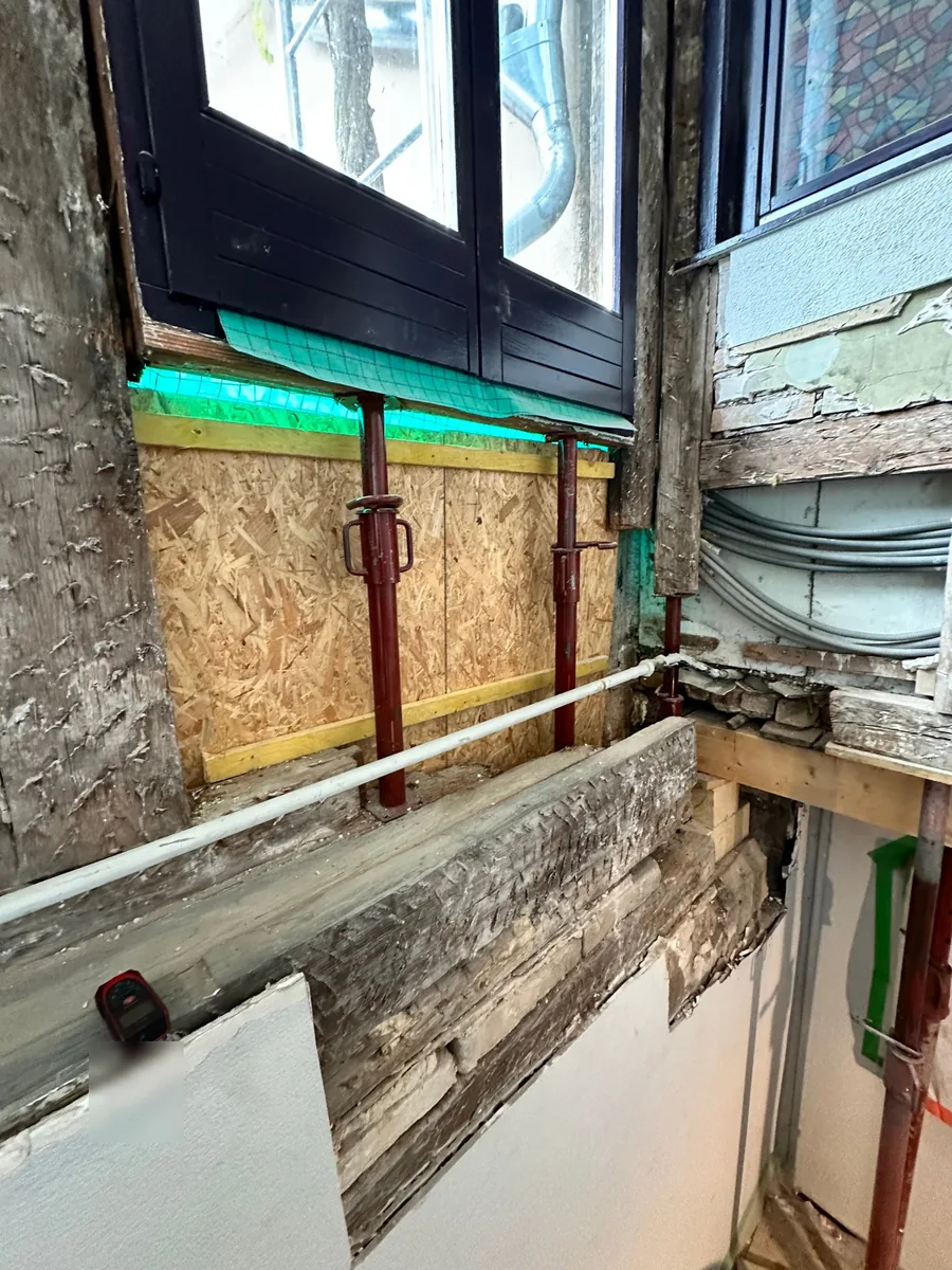 Étais métalliques sous l'allège d'une fenêtre pendant le renforcement d'un pan de bois